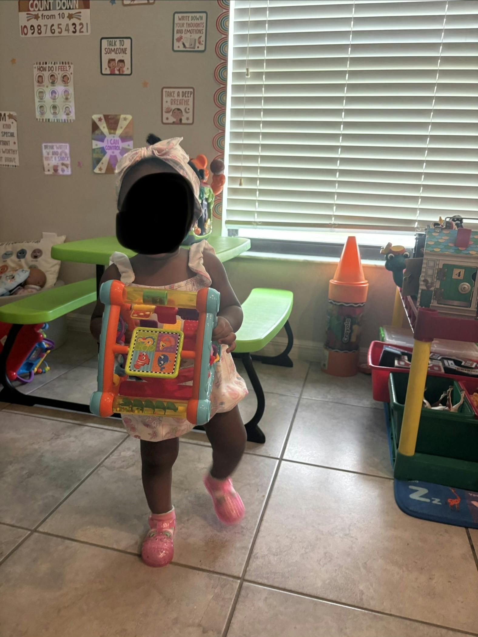Child playing with a toy in a playroom