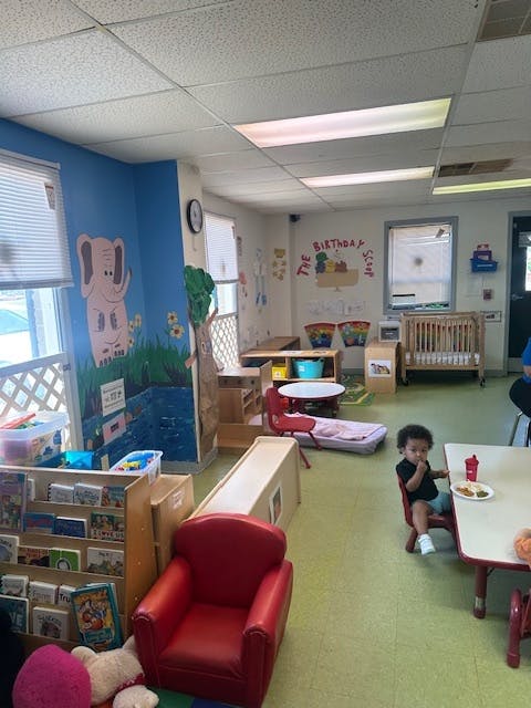 Child eating at a table in a classroom