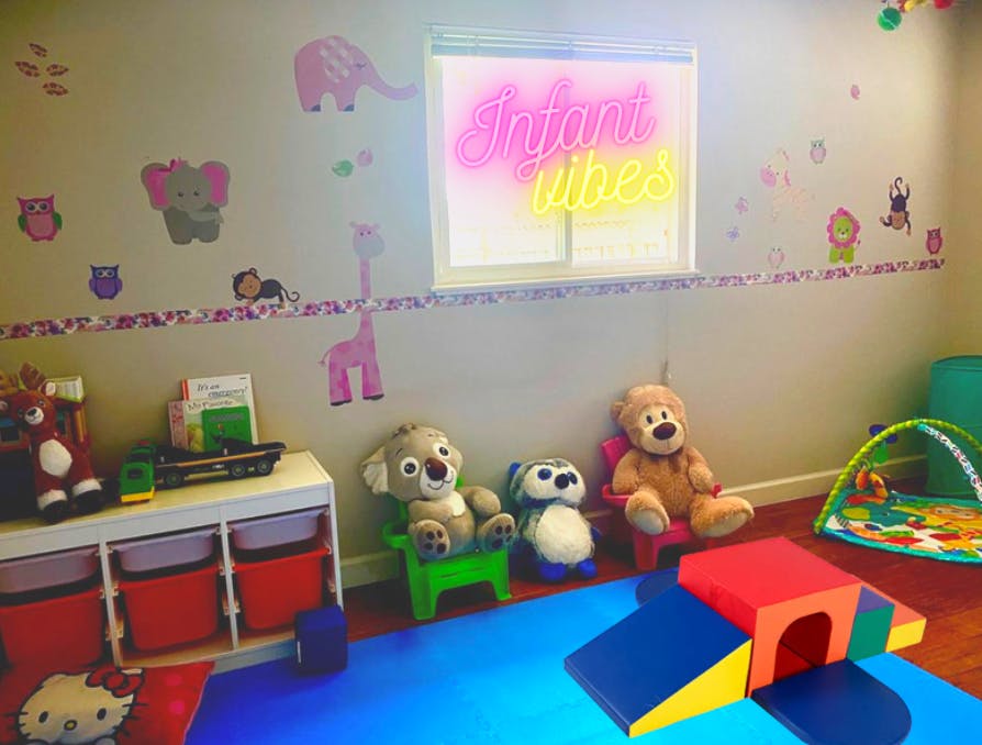 Playroom with stuffed animals, play mat, and soft play equipment