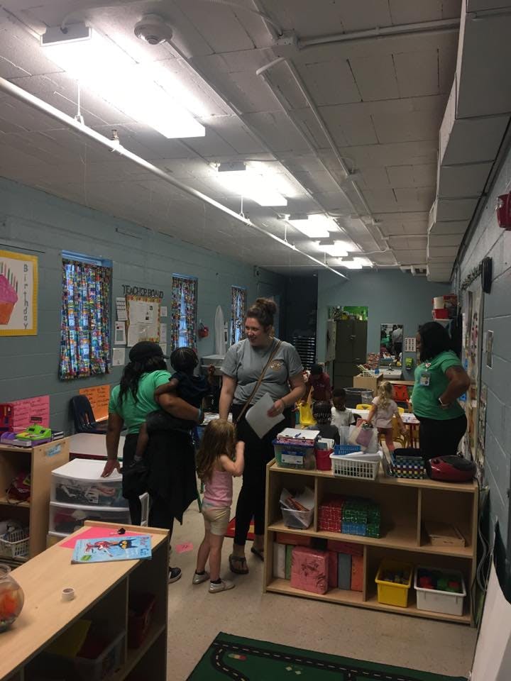 Adults and children in a classroom