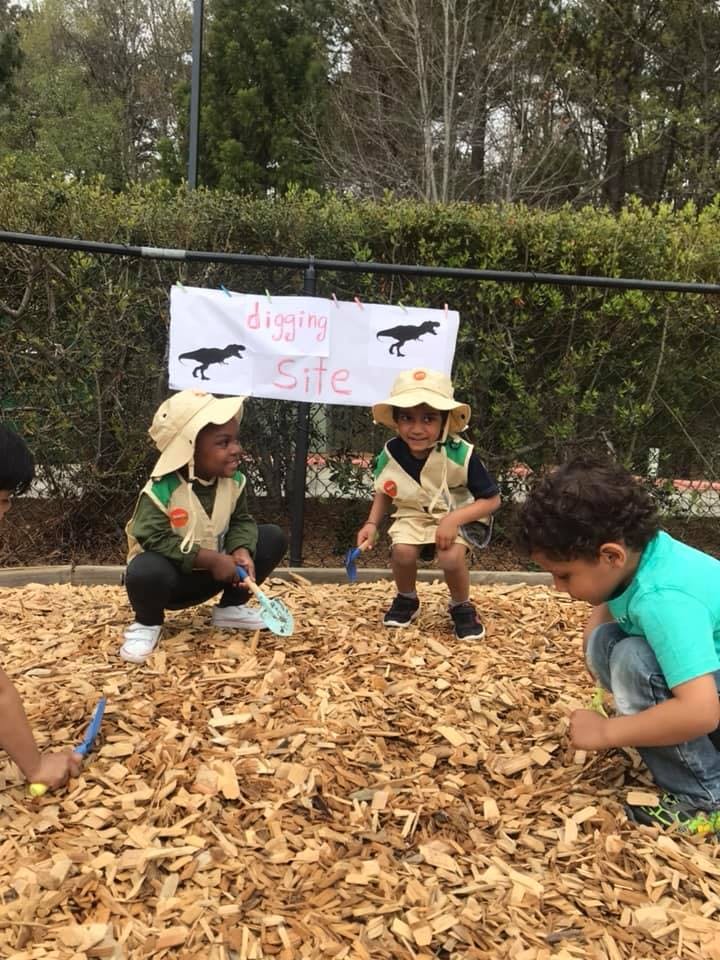 Children digging in wood chips at a "Digging Site"
