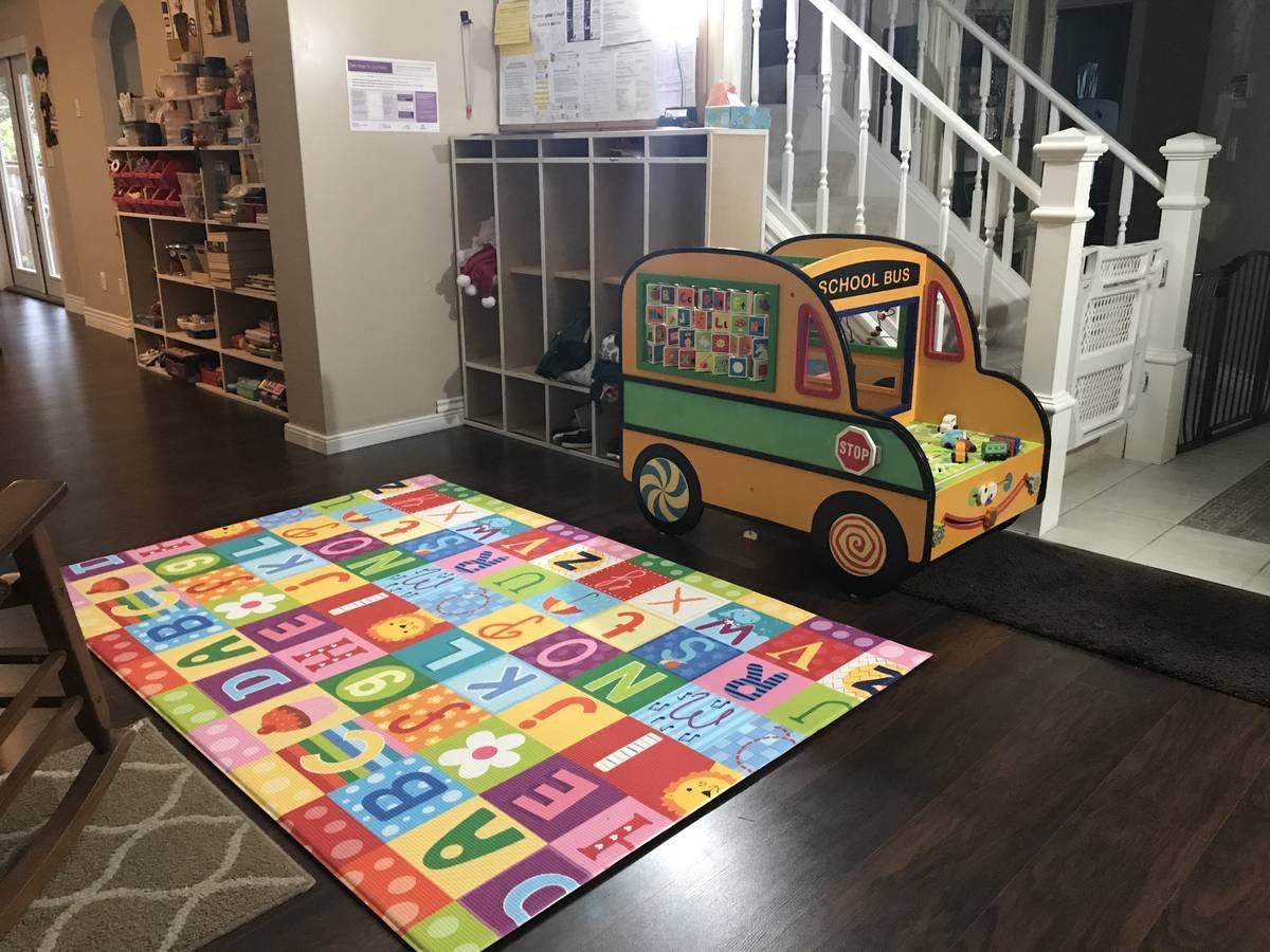 Alphabet rug and a toy school bus
