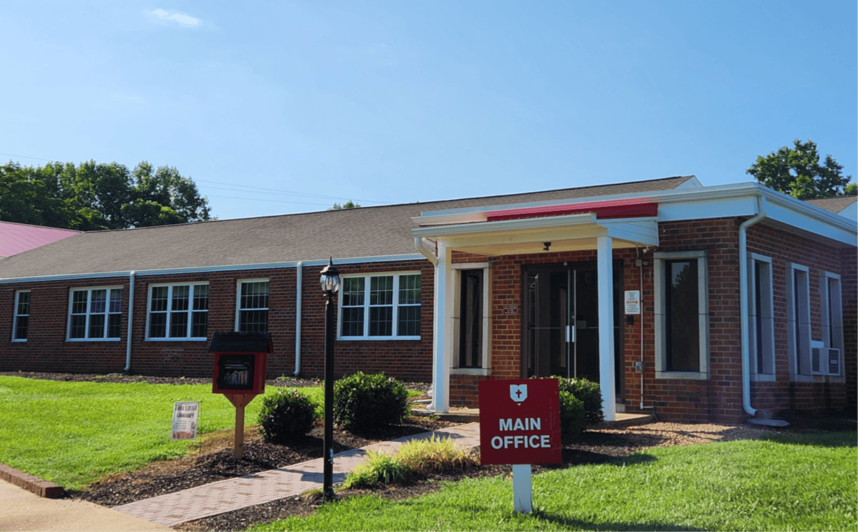 Brick building with a "Main Office" sign in front
