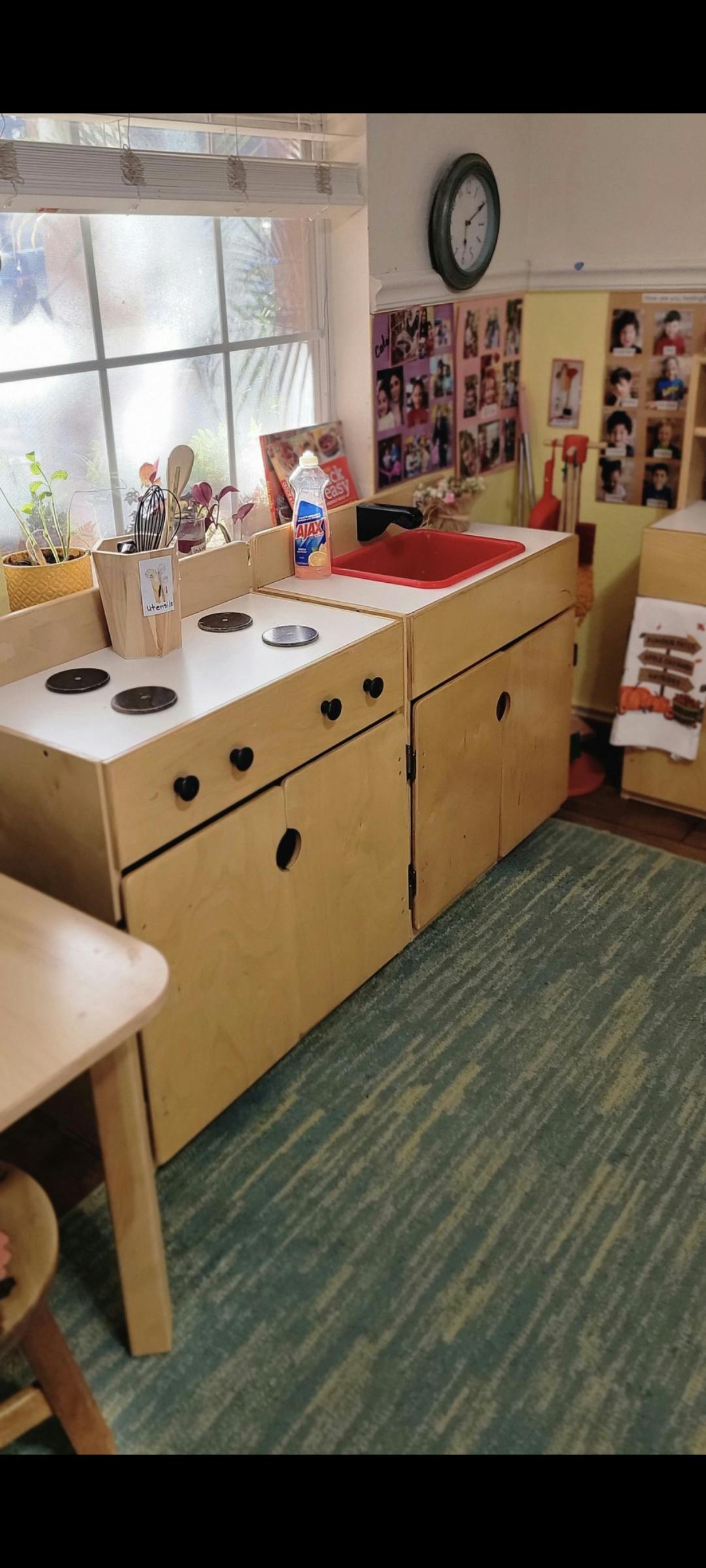 Play kitchen in a classroom with a window