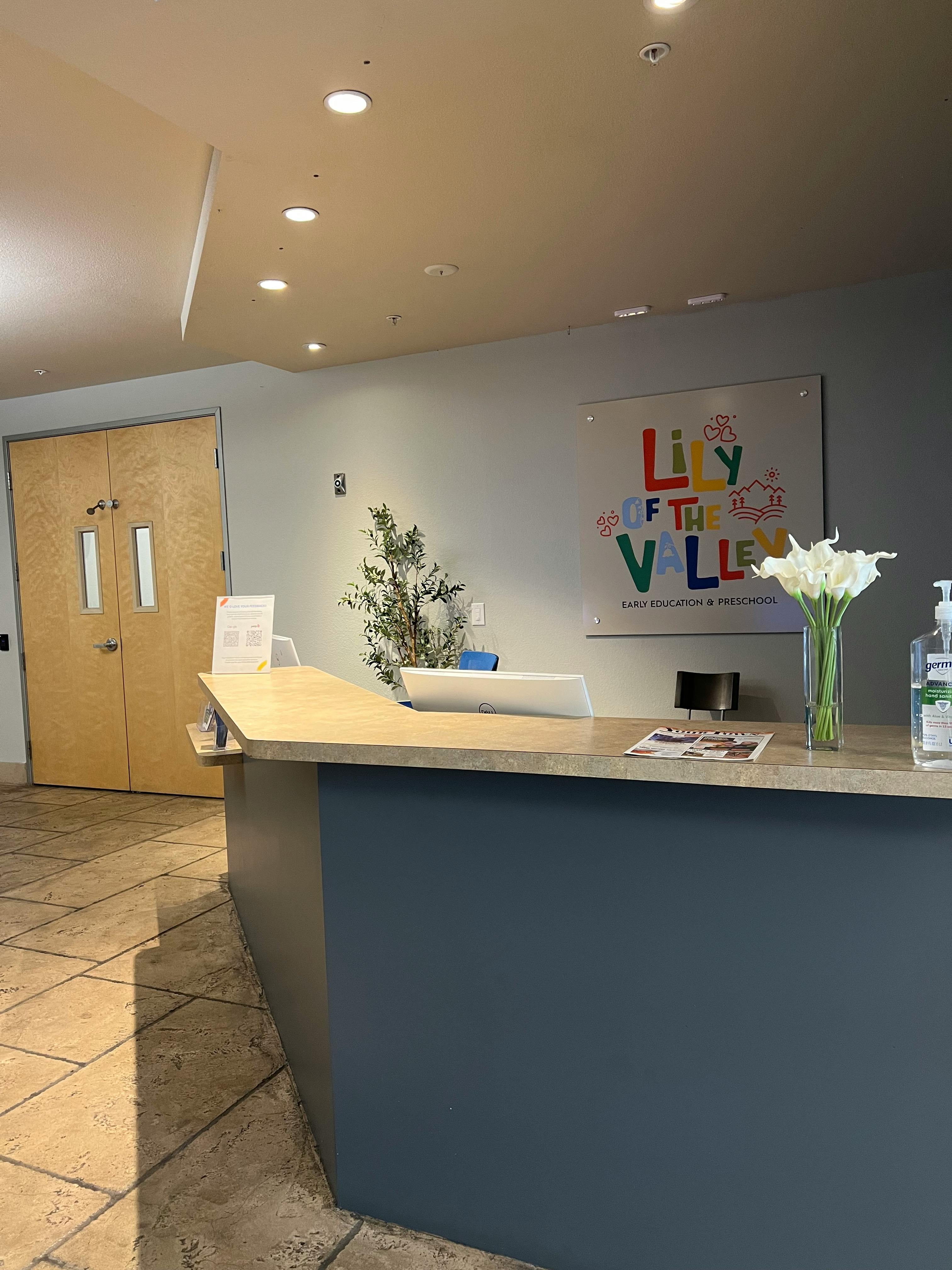Reception desk with a sign that reads "Lily of the Valley"