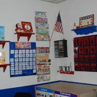 Classroom wall with calendar, American flag, and various decorations