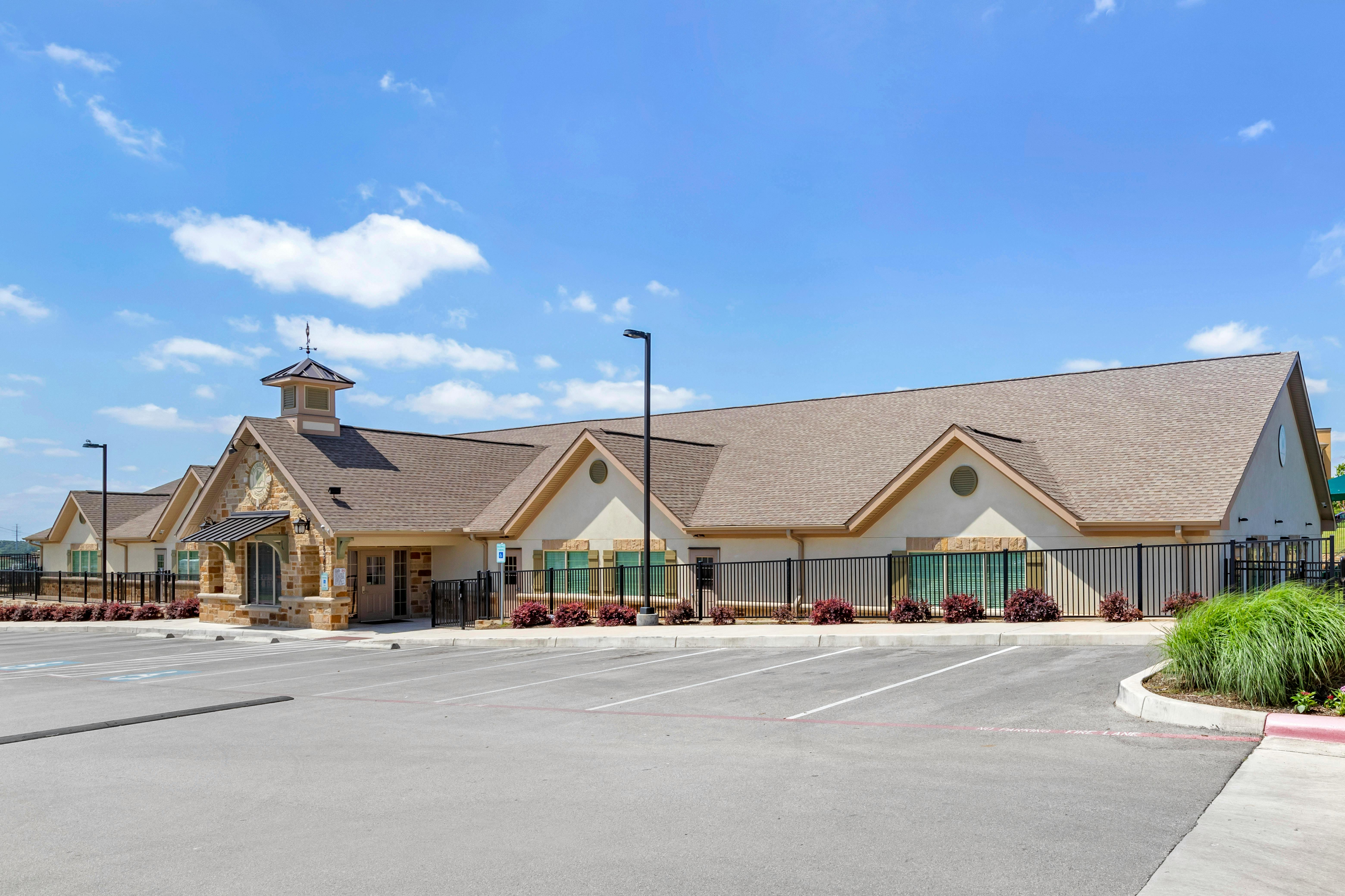 Building with a cupola and a parking lot
