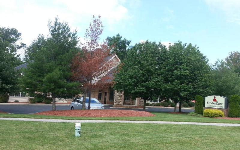 KinderCare Learning Centers sign with building and trees in background