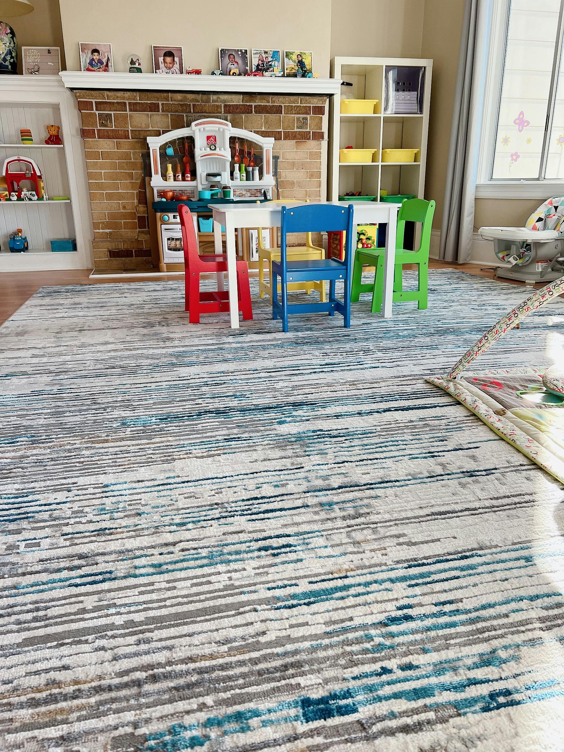 Children's play kitchen and table with colorful chairs