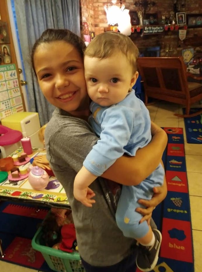 Teen holding a child