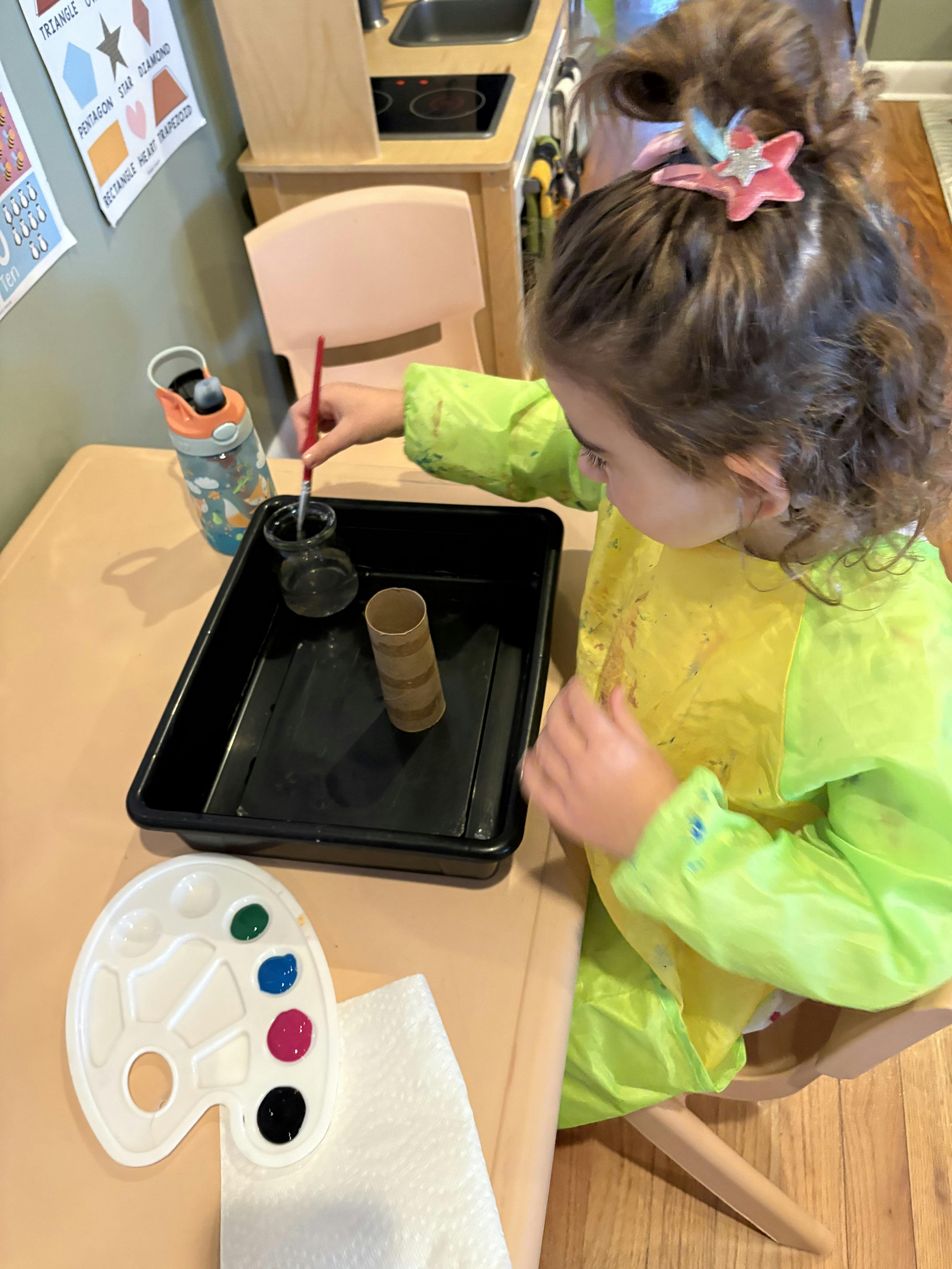 Child painting at a table