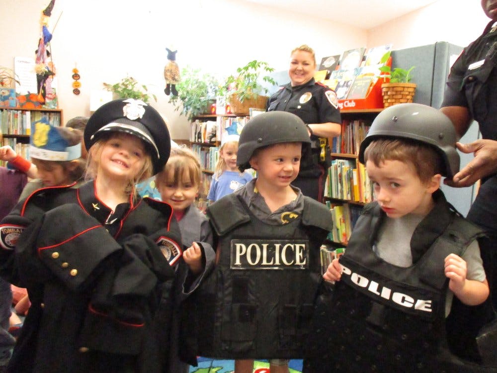 Children dressed in police and military uniforms