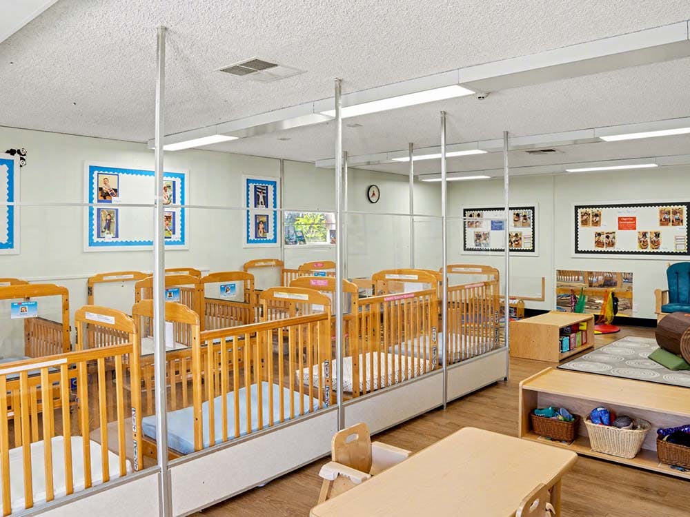 cribs in a daycare room