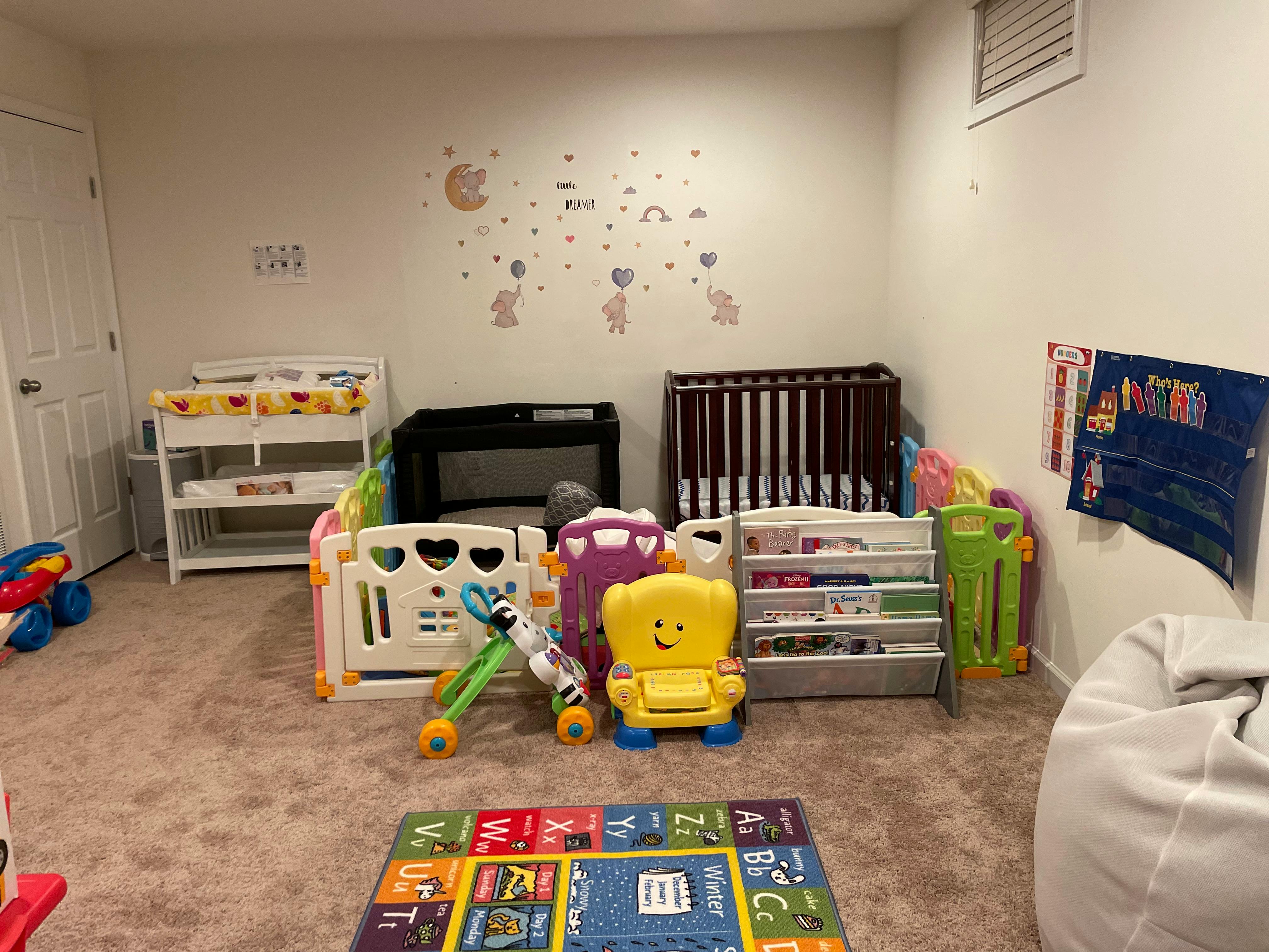 Nursery room with cribs, changing table, and children's toys