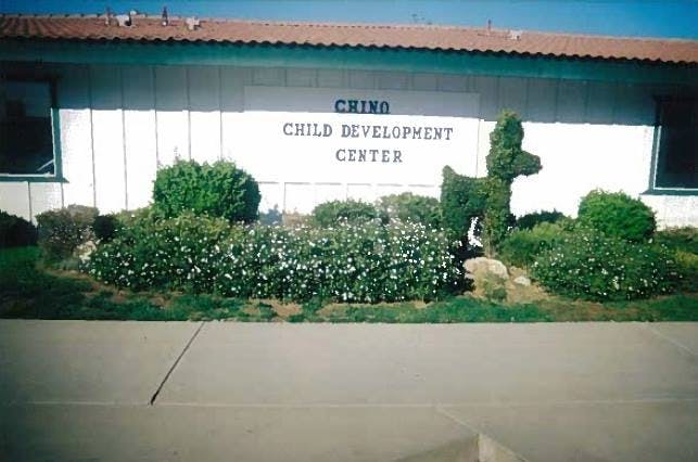 Chino Child Development Center building with bushes and topiary