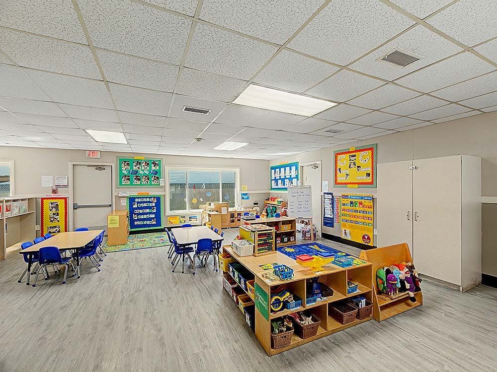 Classroom with small tables, chairs, and learning materials