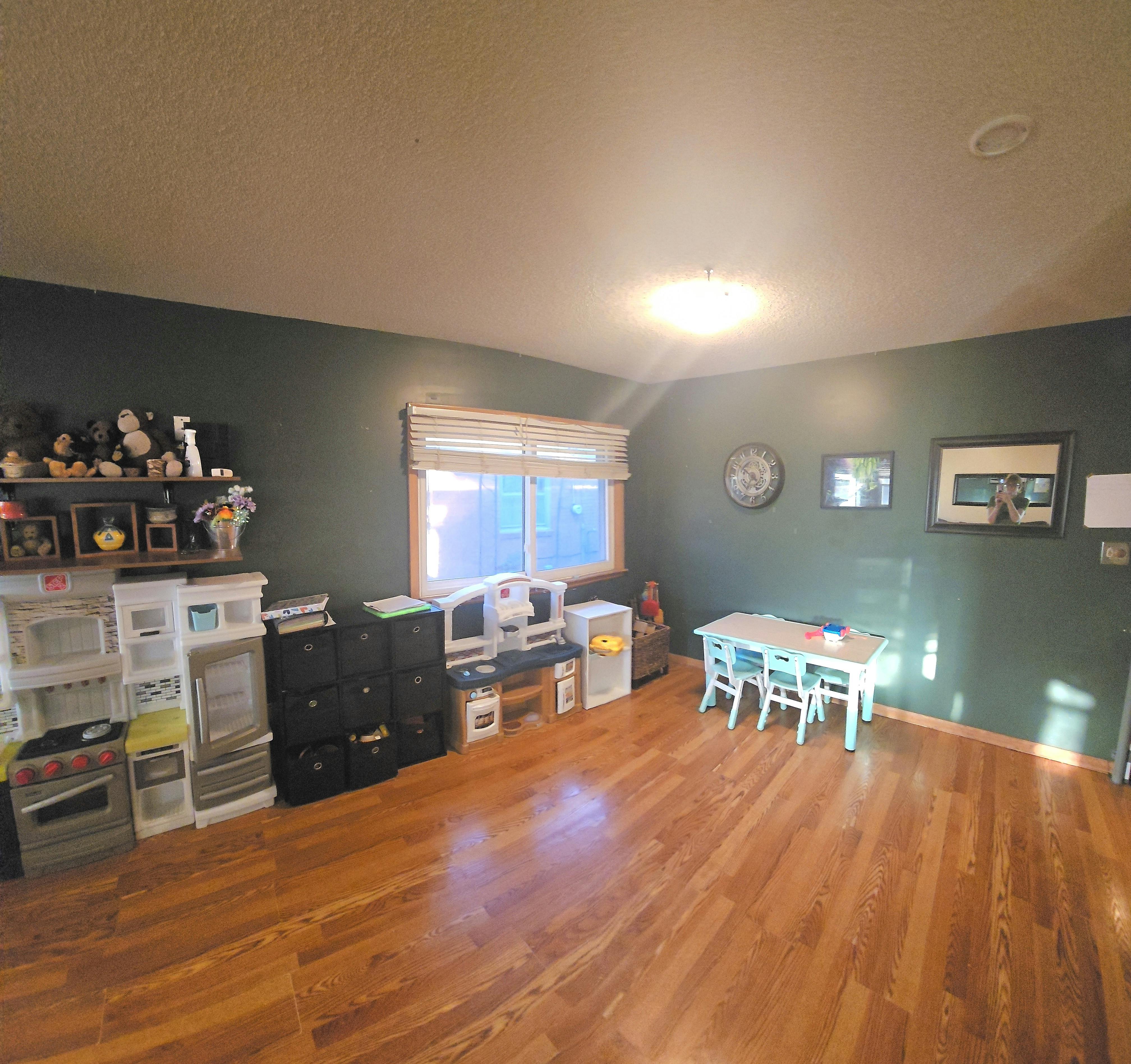 Room with a window, small table and chairs, and various storage units