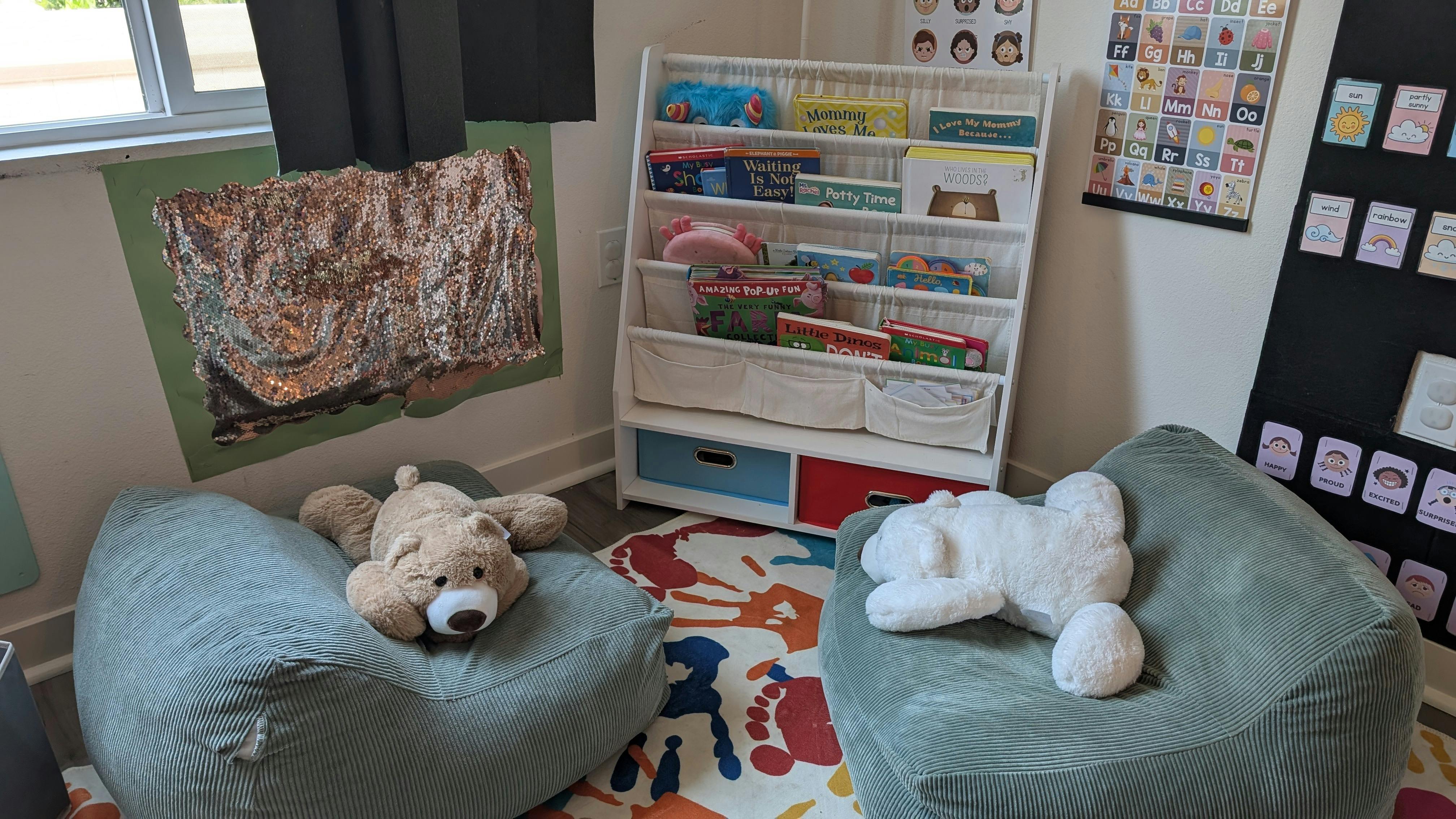 Two beanbag chairs with stuffed animals in a classroom reading nook