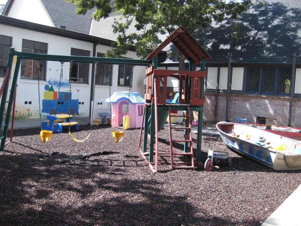 Playground with swings, playhouse, and boat