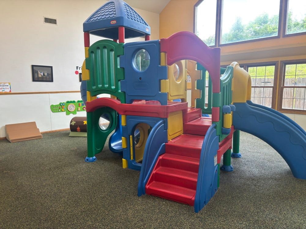 Colorful indoor playground with slides and steps