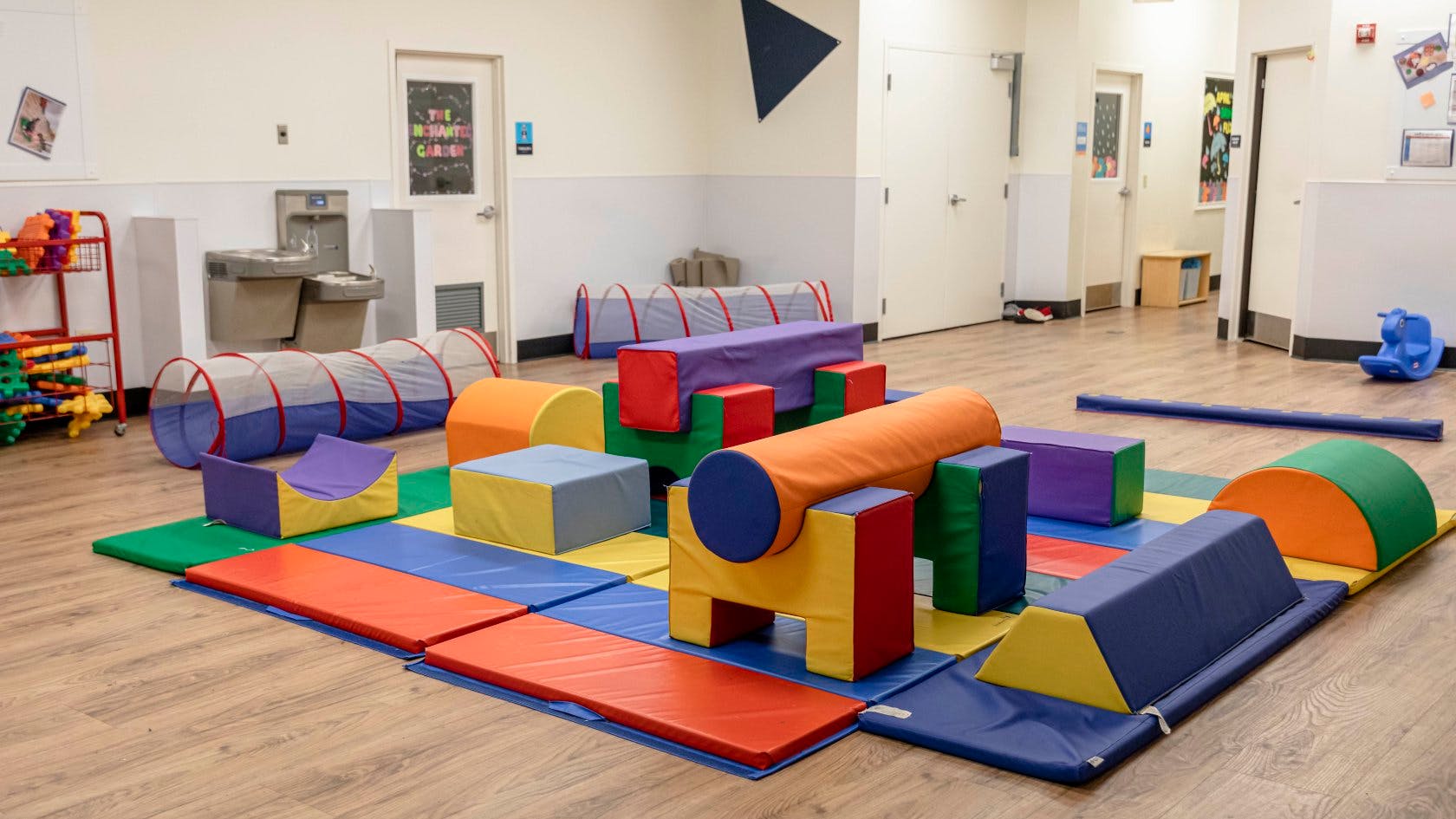 Colorful soft play equipment on mats in a children's play area