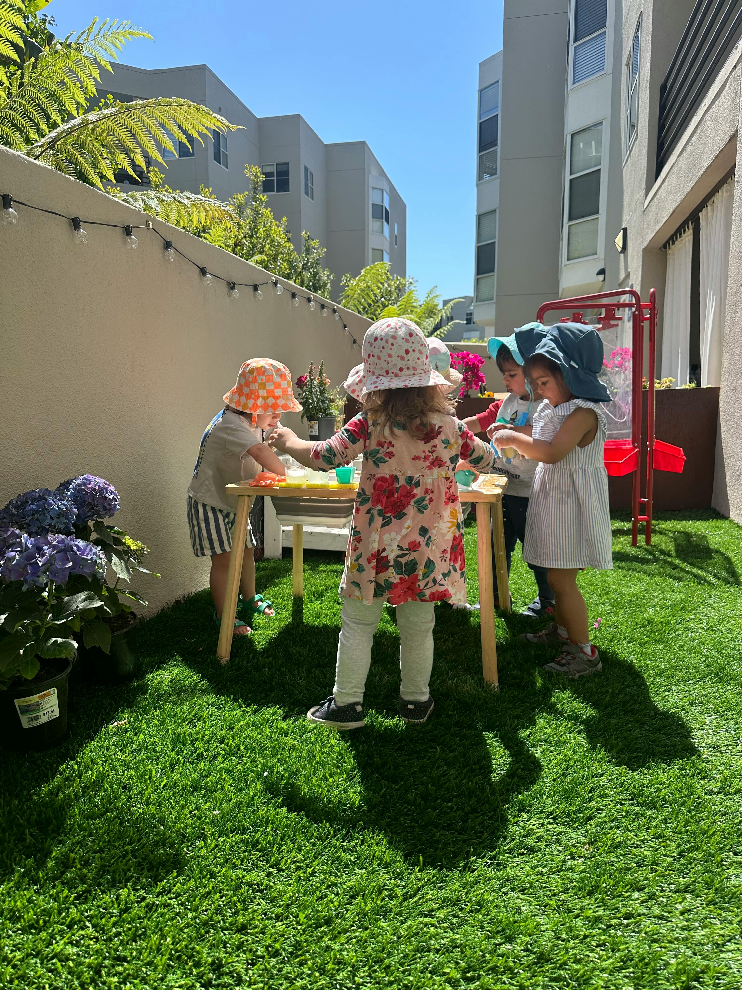Children playing at a small table outdoors