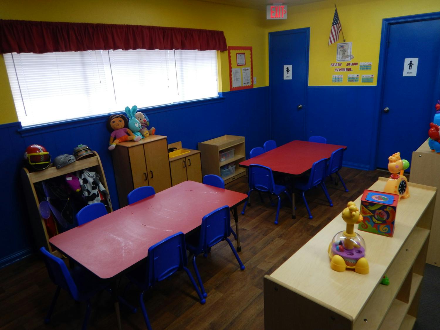 Classroom with small red tables and blue chairs