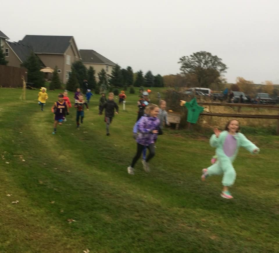Children running on a grassy field