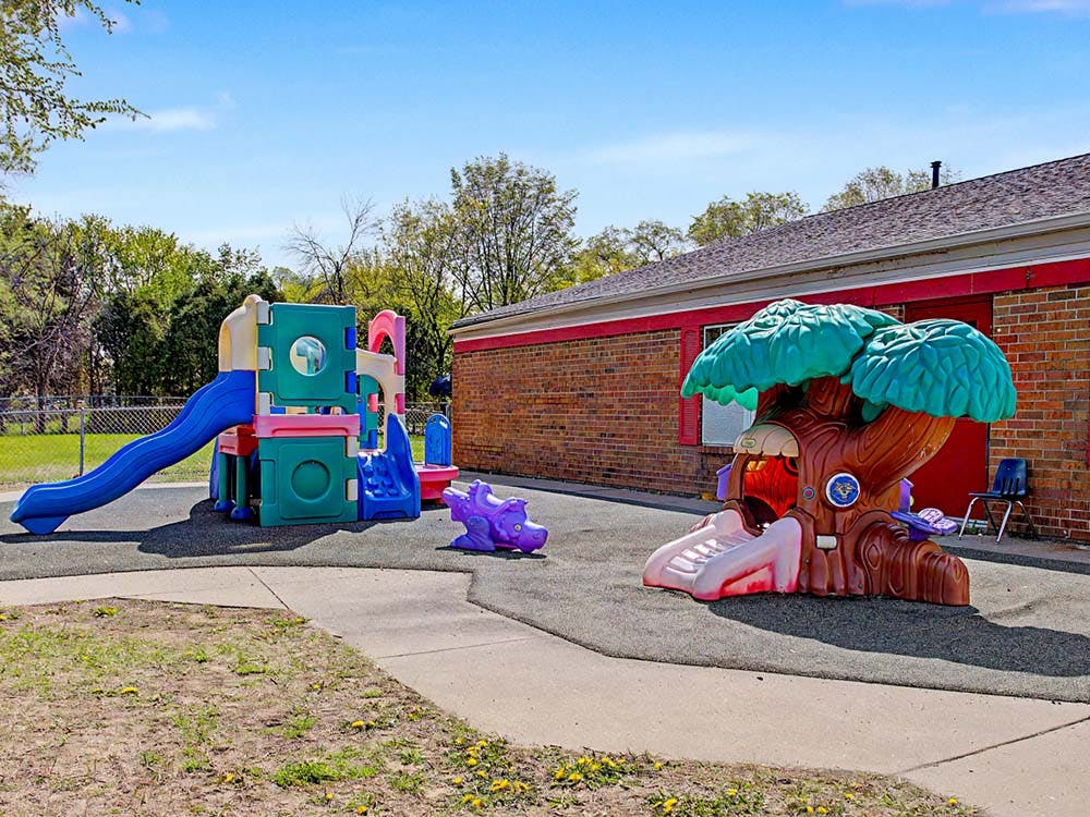 Colorful playground set with a slide and a tree-shaped play structure