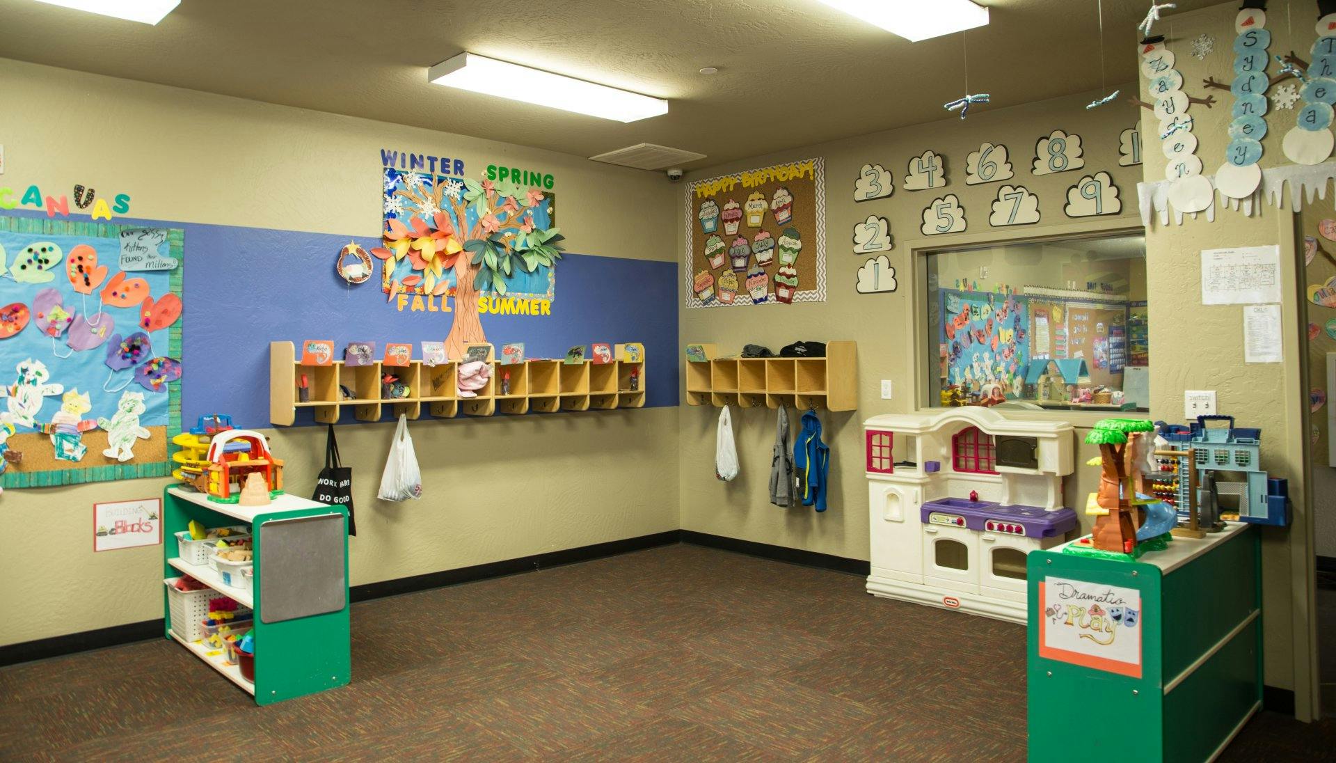 Empty classroom with cubbies and play kitchen
