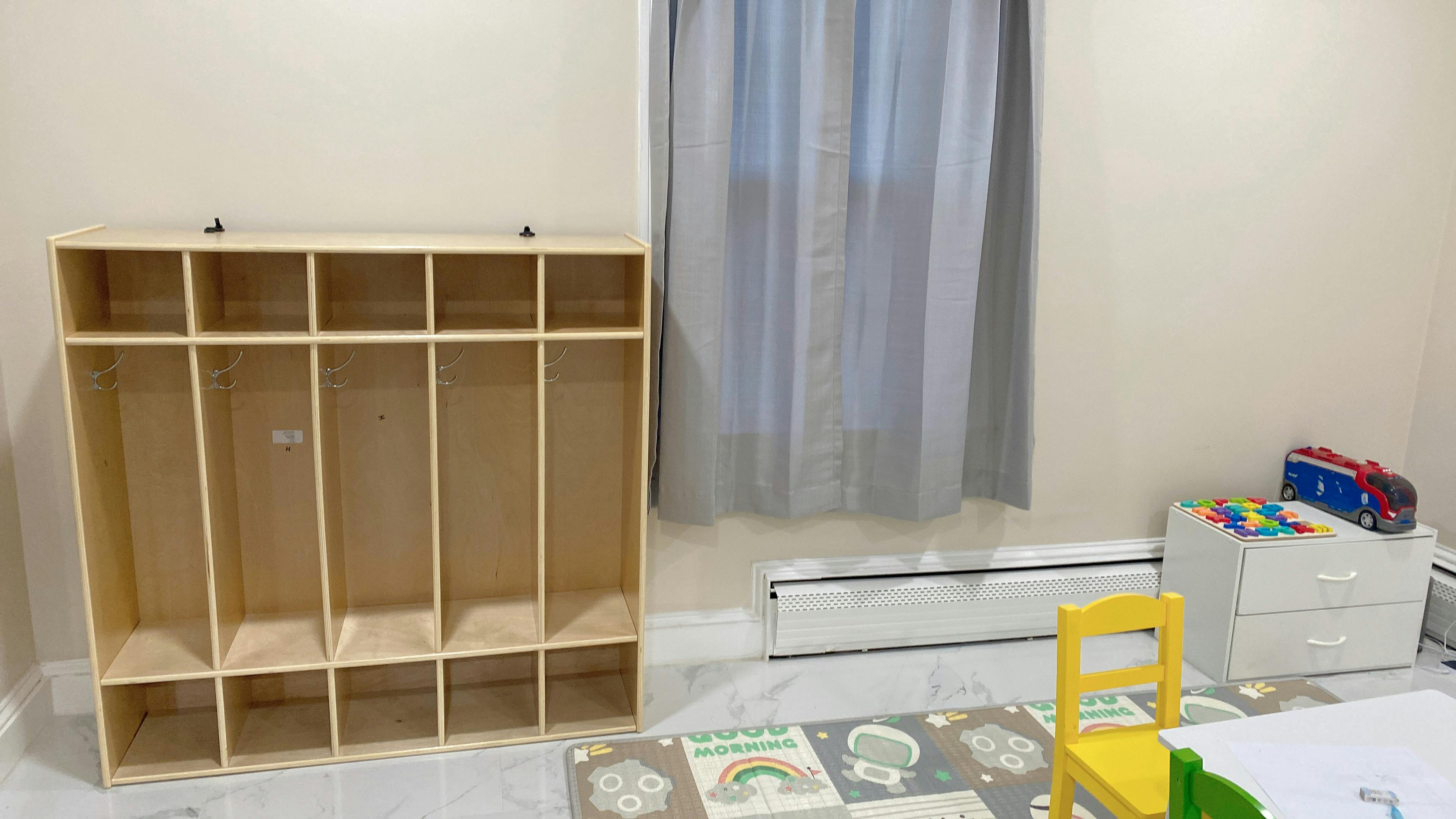 Empty wooden cubby shelf in a room