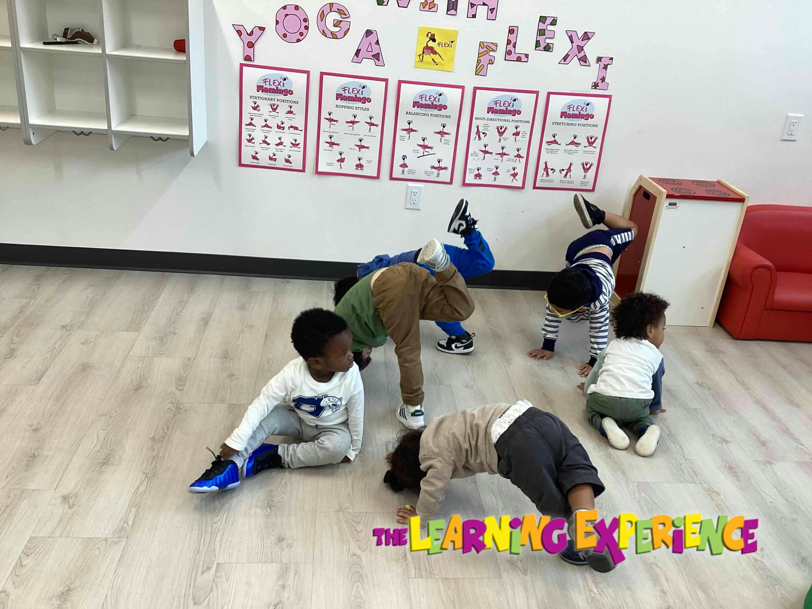 Children doing yoga poses in a classroom