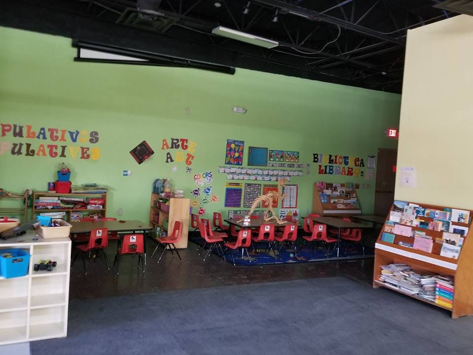 Classroom with small tables and chairs, decorated walls
