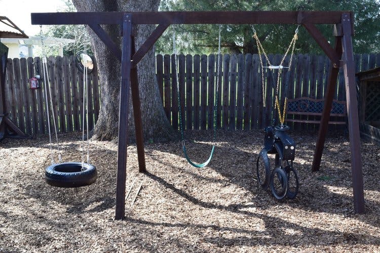 Swing set with a tire swing and a green swing