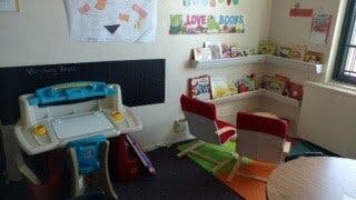 Child's play area with small desk, chairs, and books
