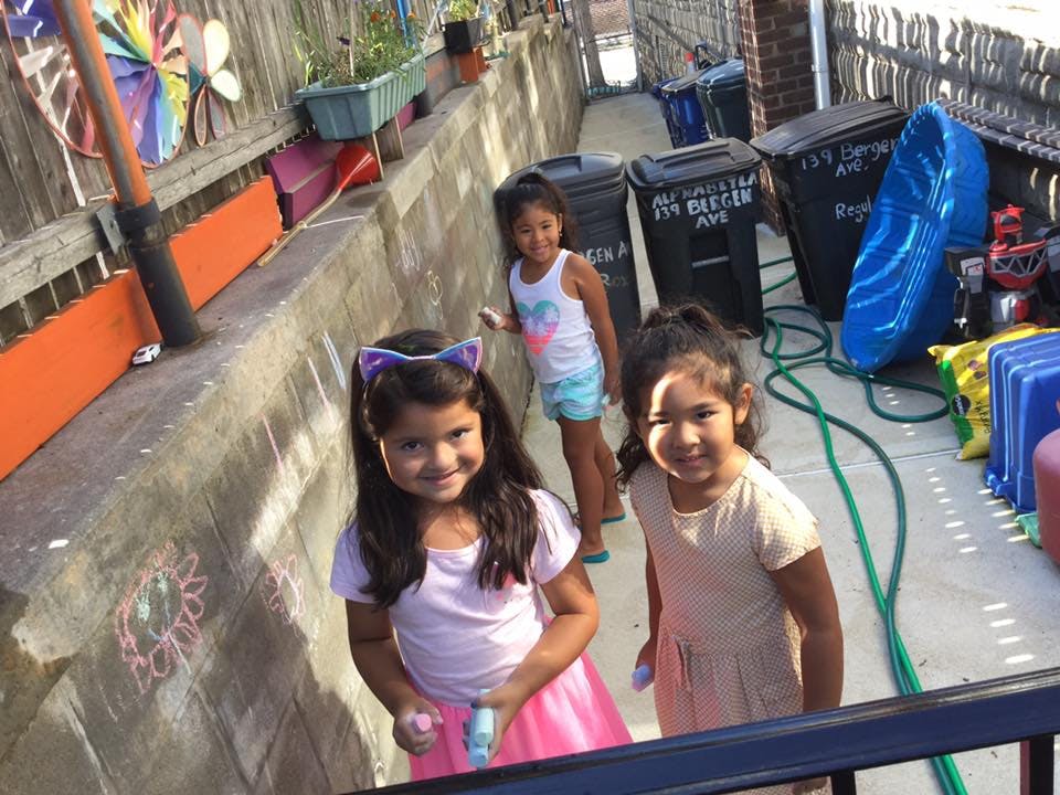 Three children standing outdoors