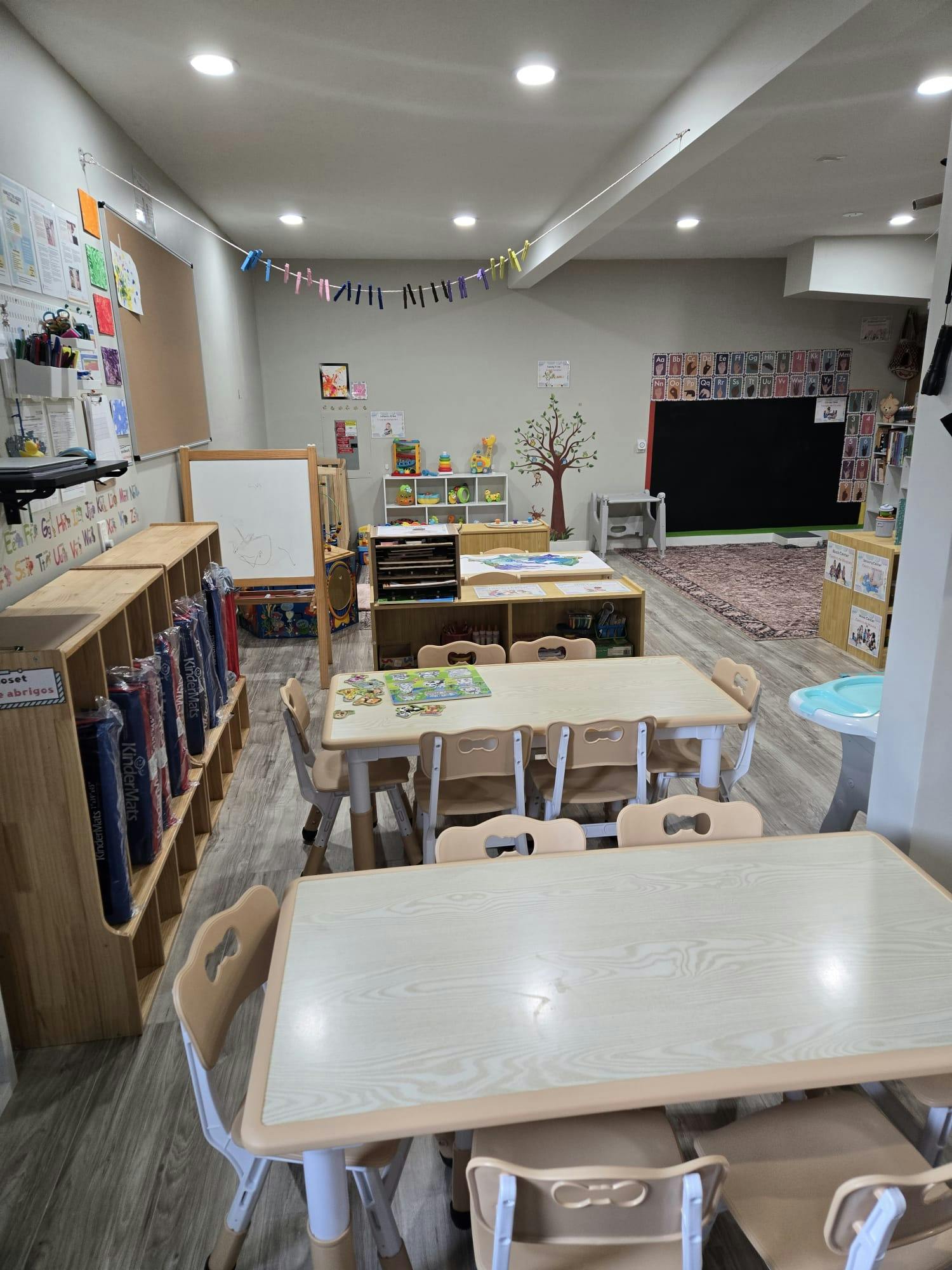 Empty classroom with small tables and chairs
