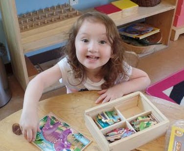 Child playing with puzzles at a table