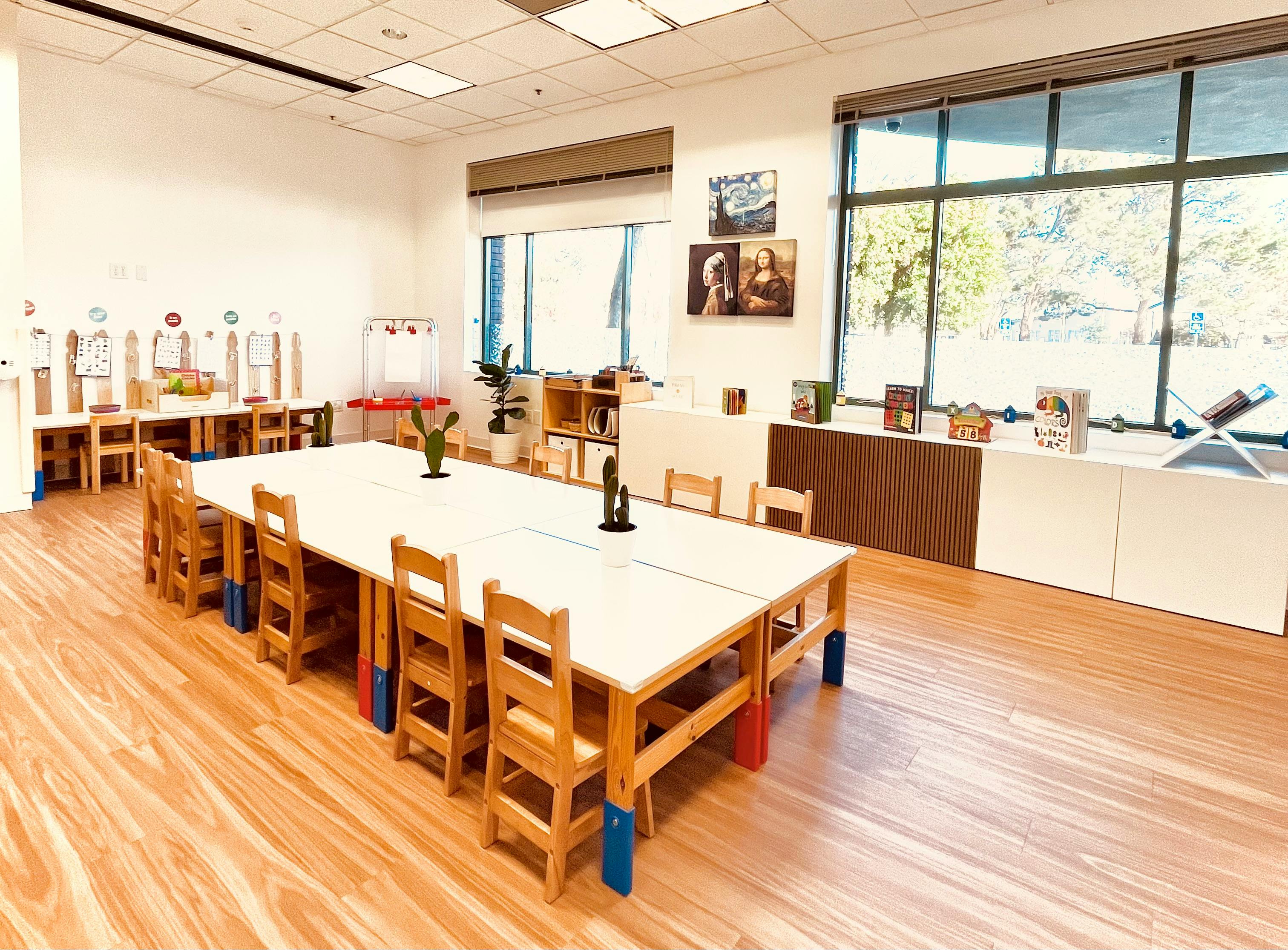 Classroom with long tables and small wooden chairs