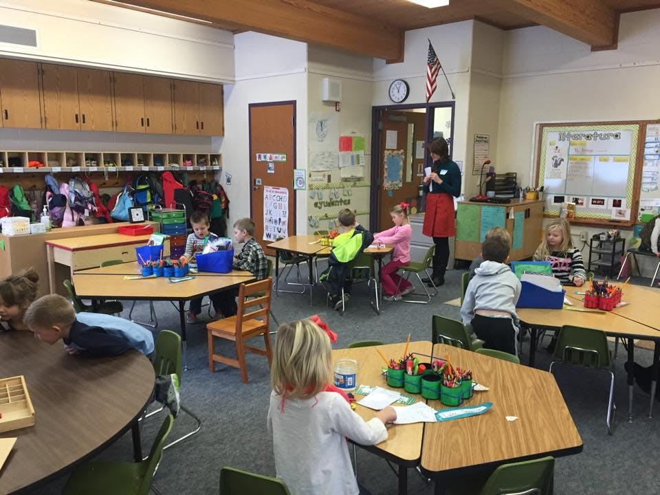 Children and an adult in a classroom