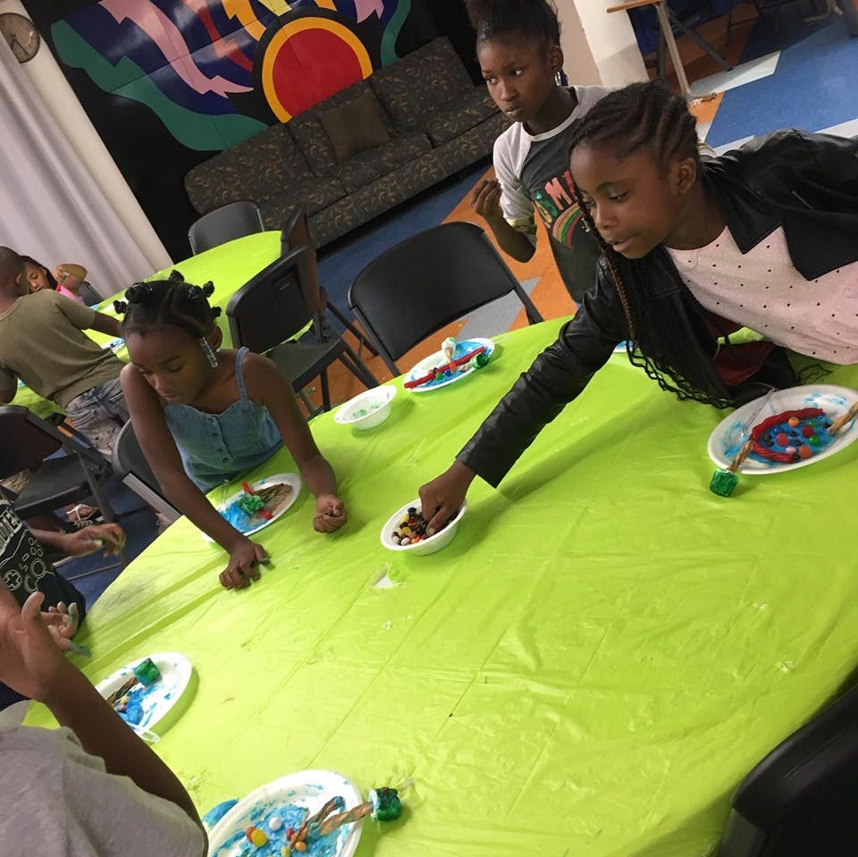 Children at a table with craft supplies