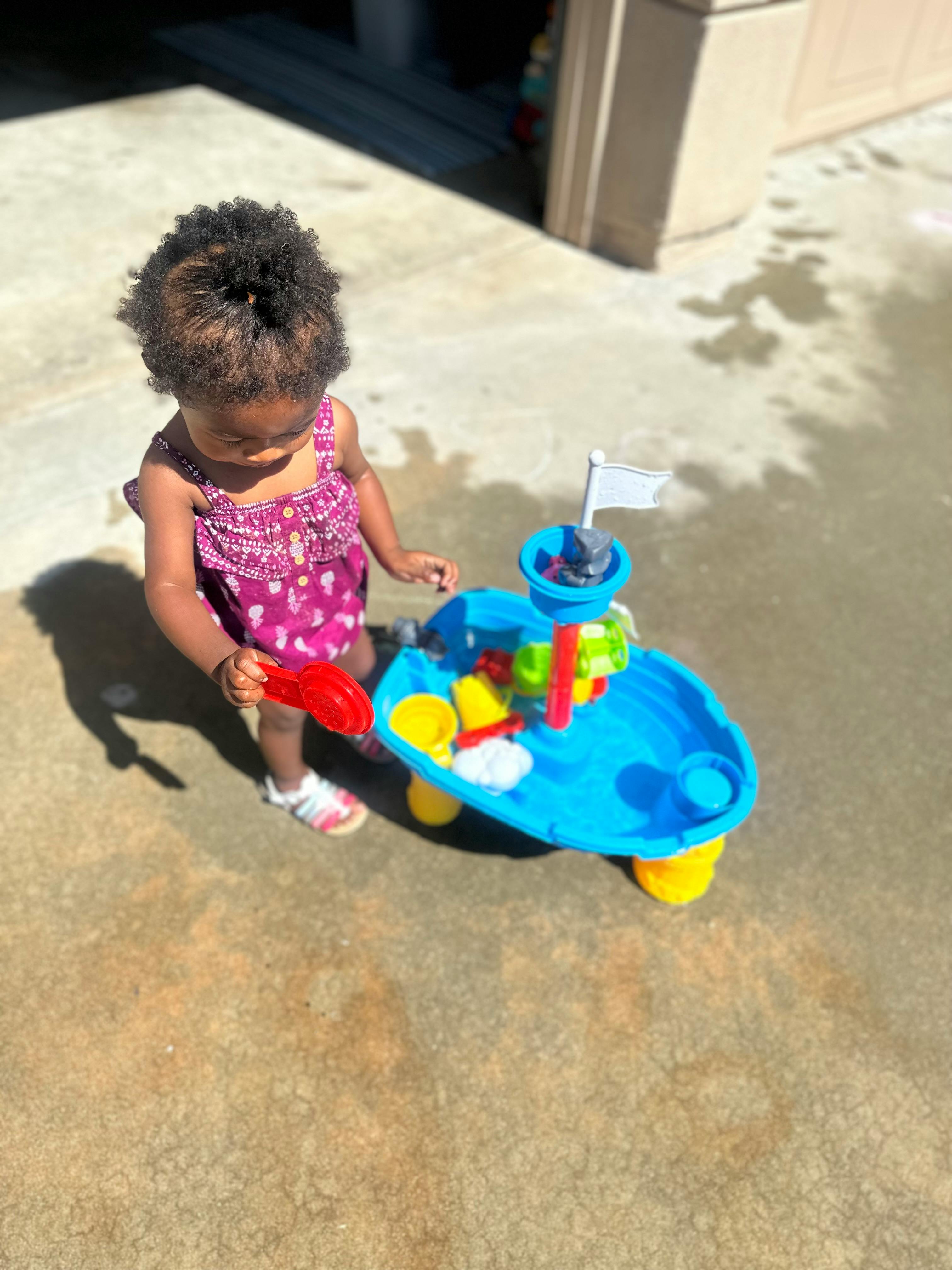 Child playing with a water table toy
