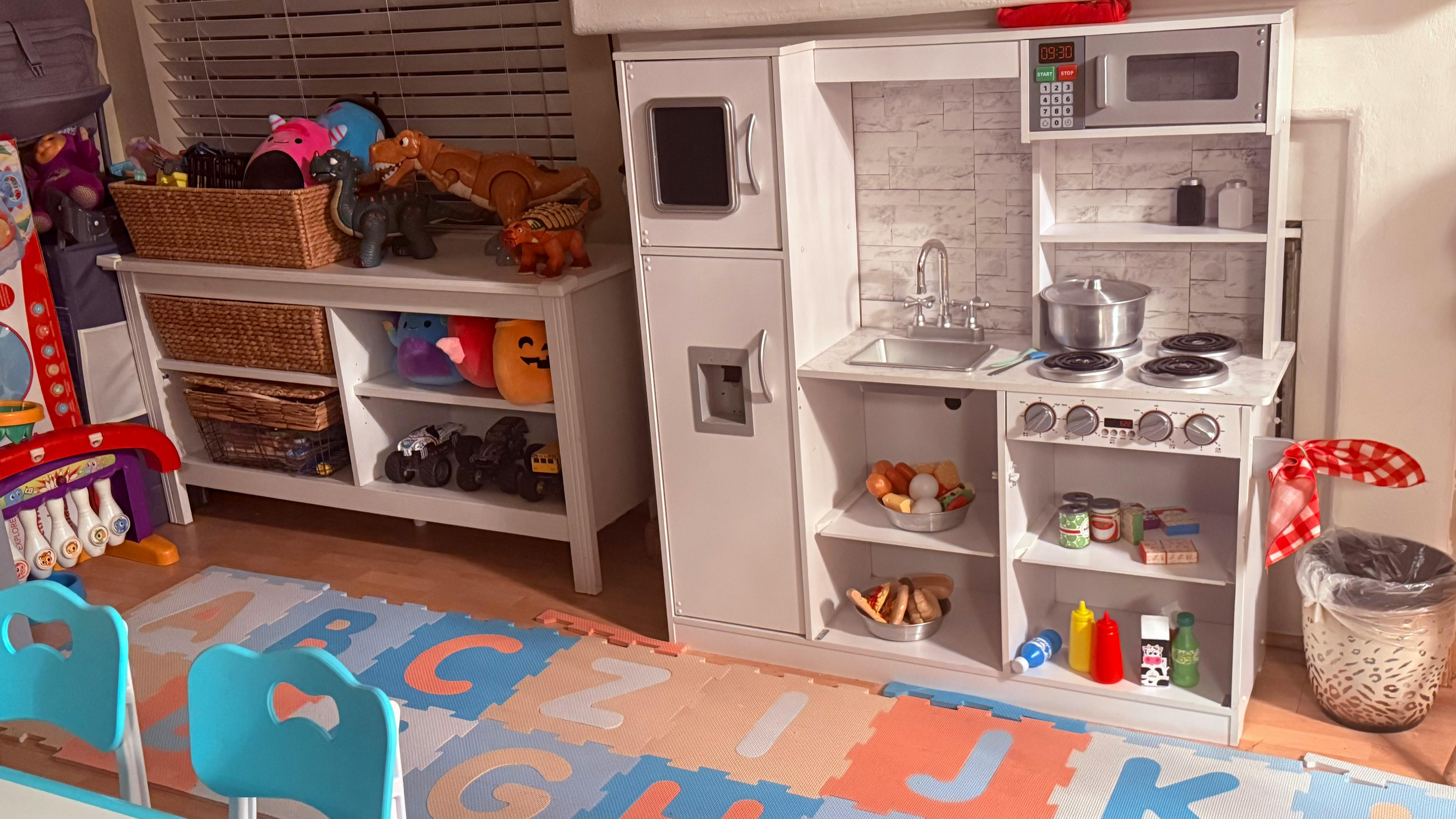 Child's play kitchen set and toy storage shelves
