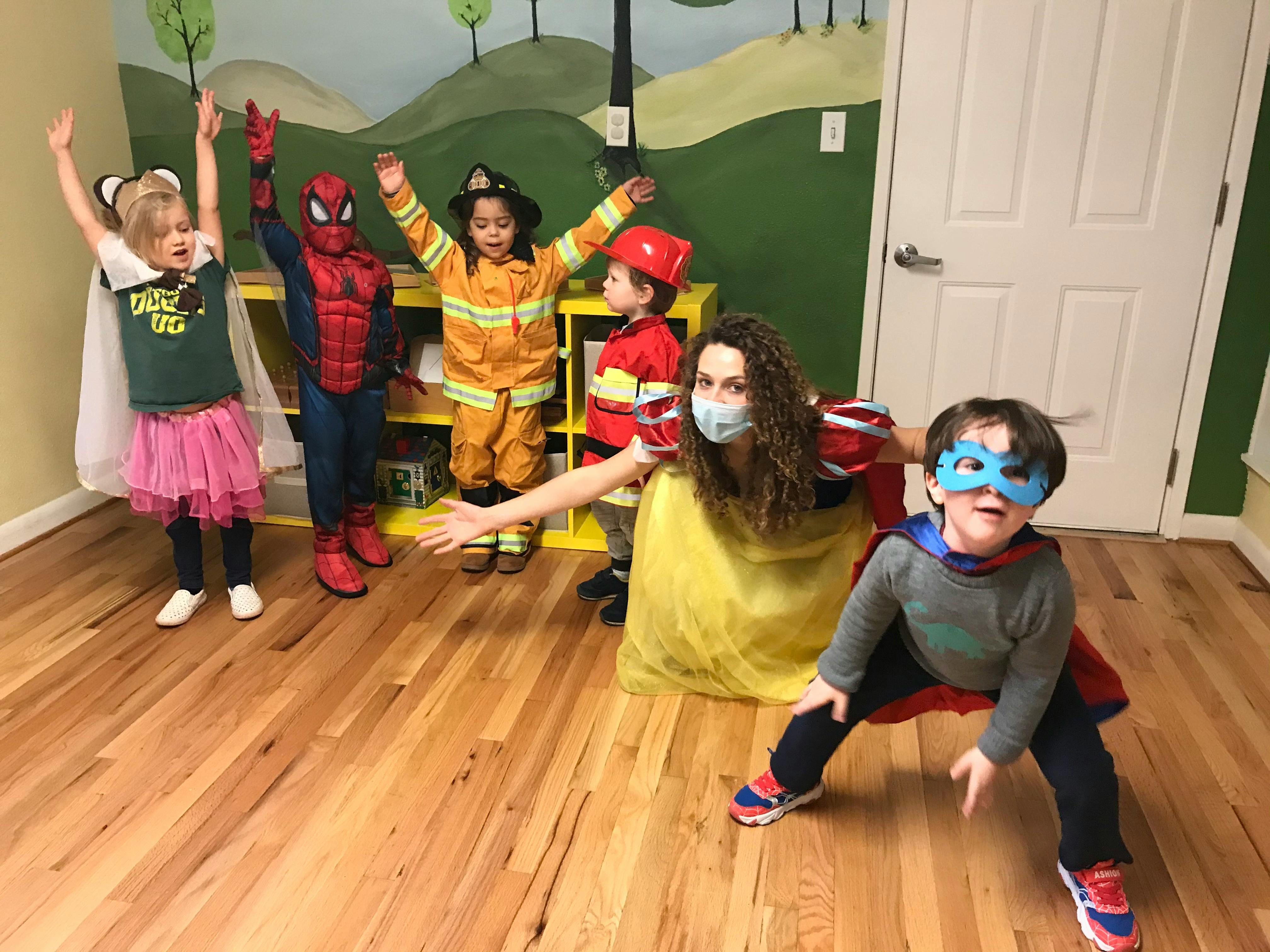 Adult and children in costumes posing indoors