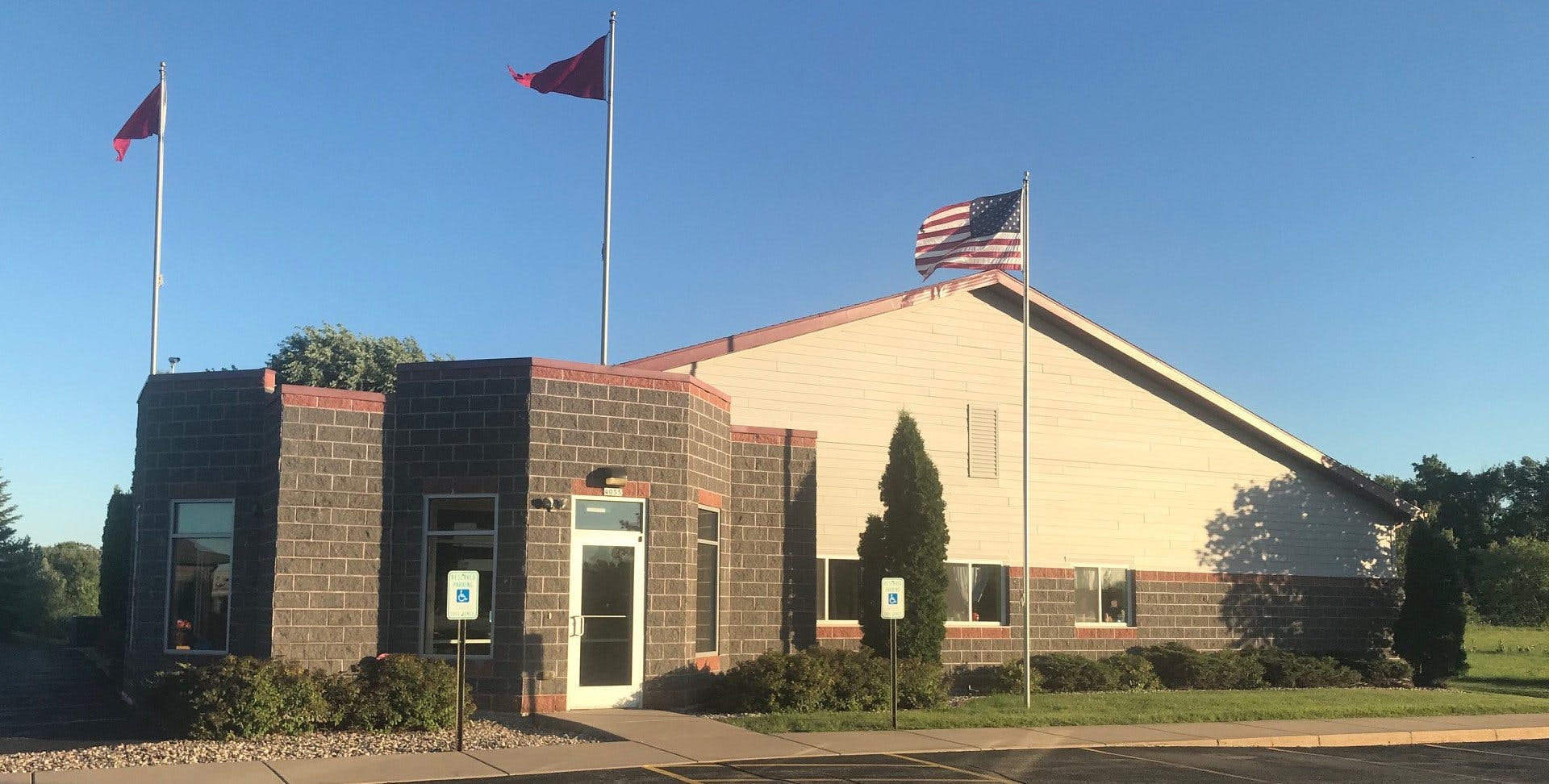 Building with brick facade and flags flying