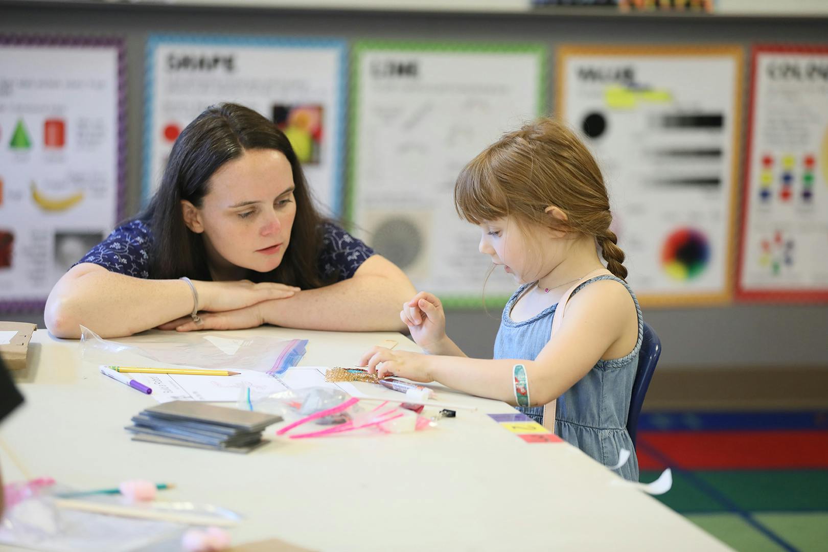Adult and child at a table with art supplies