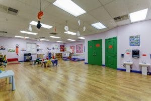 Empty classroom with small tables and chairs