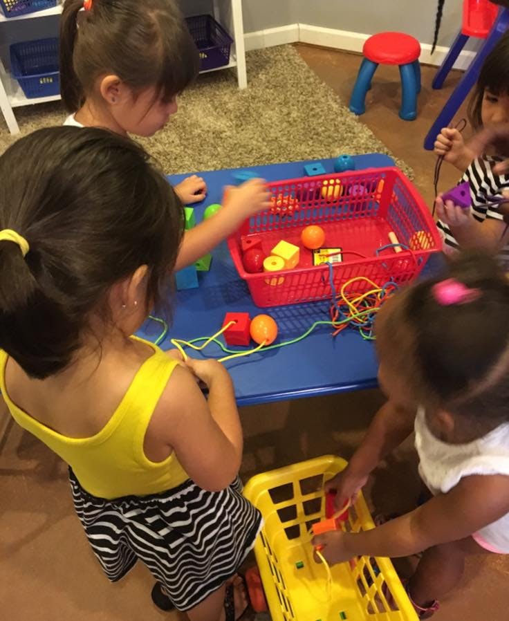 Children playing with toys at a table