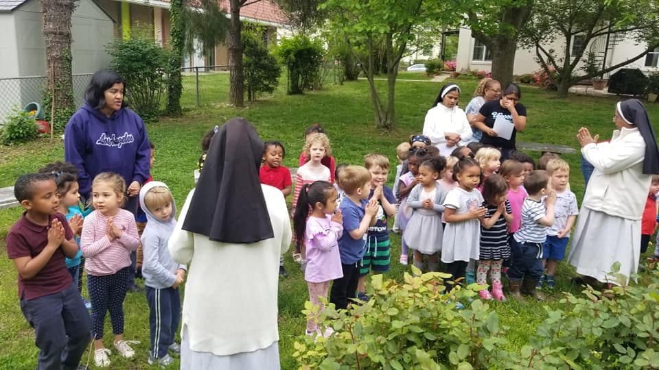 People and children standing outdoors