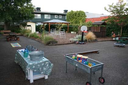 Outdoor play area with tables, a basketball hoop, and a gazebo